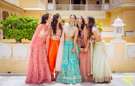 Cute bridesmaid photo with bride in blue lehenga