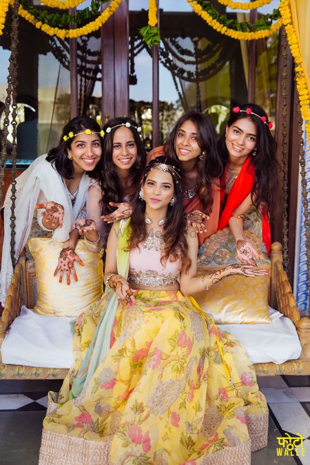 Bride and bridesmaids on mehendi with wreaths