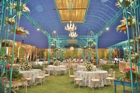 Blue and white themed indoor venue decor with tables