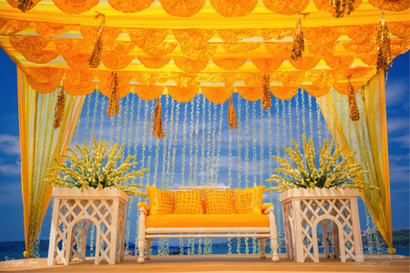 Yellow tent decor with floral strings and matching seating