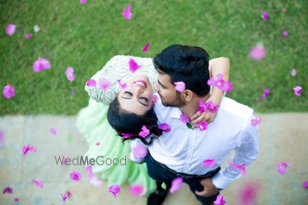 Couple portrait with falling flower petals