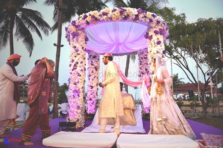 Photo of circular lavender outdoor mandap with flowers
