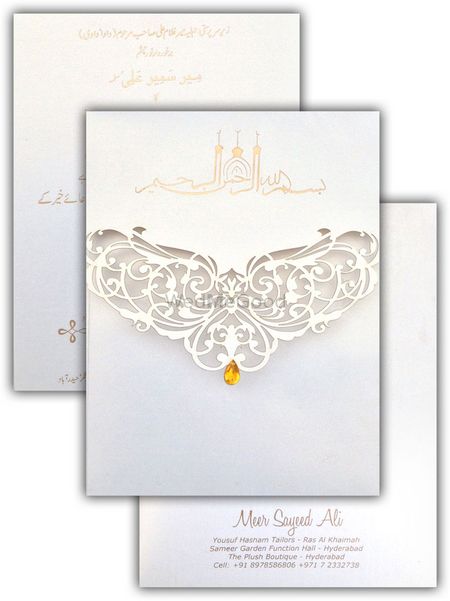 Photo of white elegant laser cut invitation cards