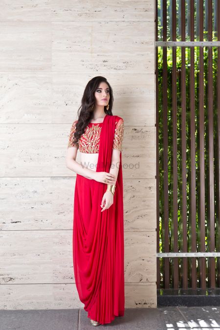 Bright red saree gown with red and gold blouse
