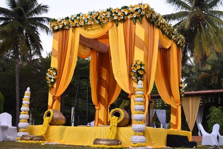 Photo of Minimal mandap decor with florals and drapes