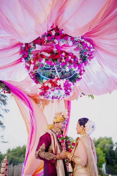 Photo of Intricate mandap decor with floral chandelier