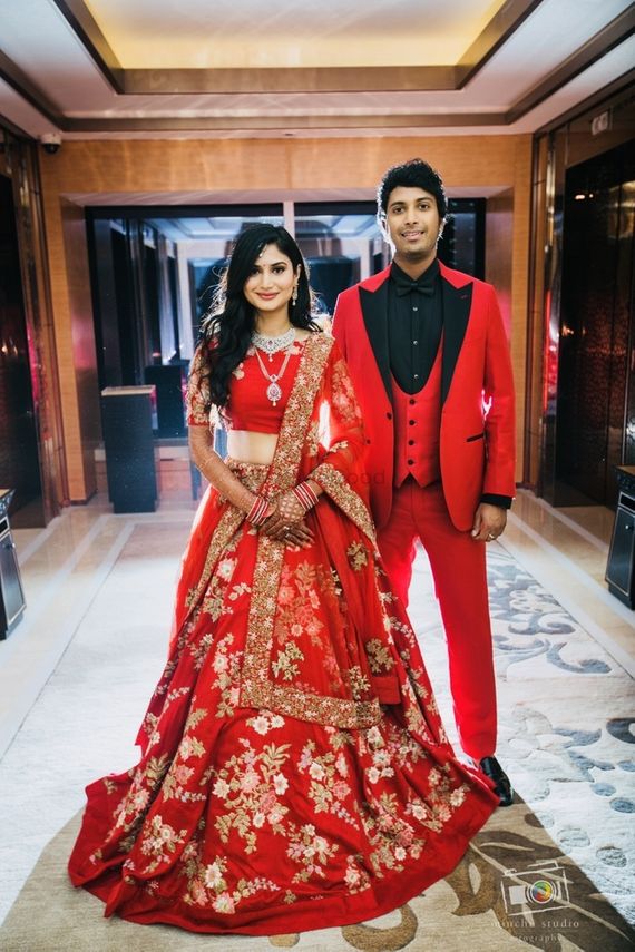 Photo Of Bride And Groom In Matching Red Outfits For Reception