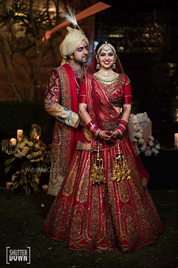 Photo Of Matching Bride And Groom In Red Outfits