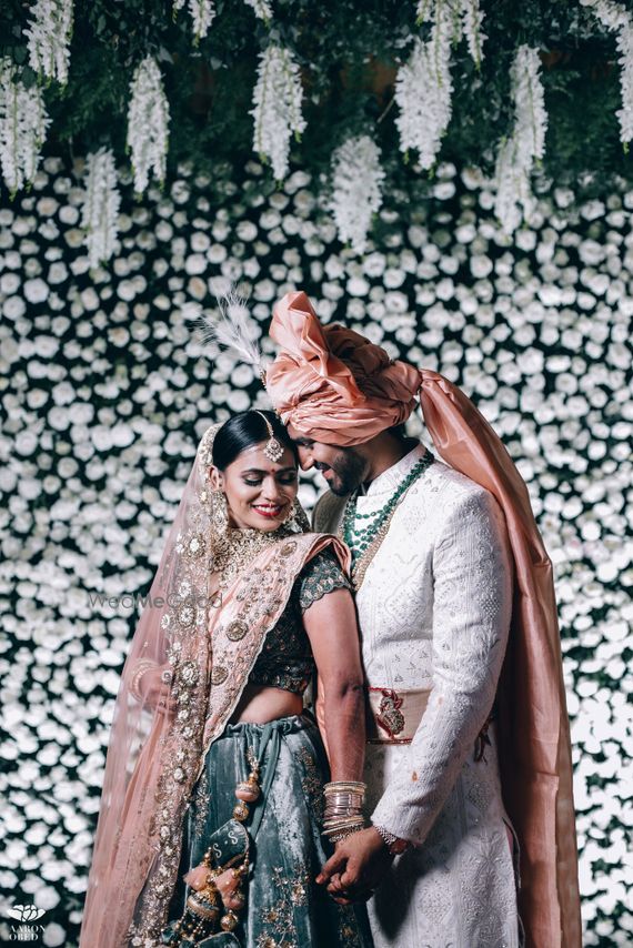 Photo Of Contrasting Bride And Groom Posing On Stage