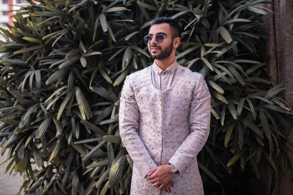 Groom in a lavender Indo western outfit 