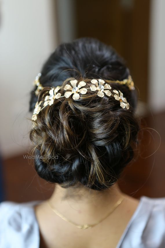 Photo Of Messy Wavy Bun With Hair Accessory