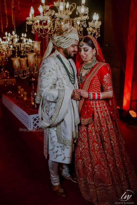 groom sherwani with red lehenga