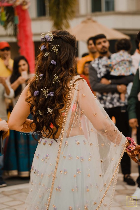 Photo Of A Glam Half Up Half Down Hairstyle Pinned With Flowers
