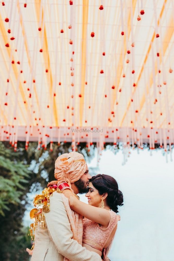 Photo of Romantic couple portrait with groom kissing bride on forehead