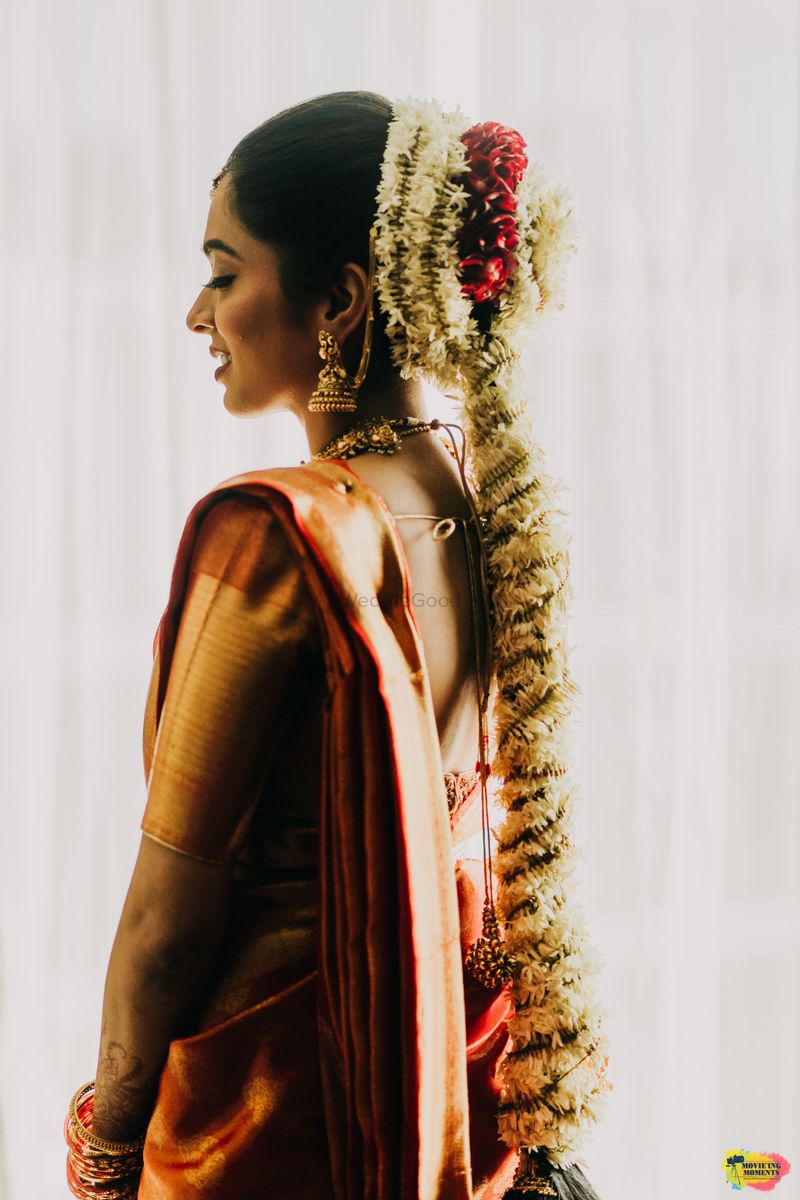 Photo of South indian bridal hairdo with a floral jada