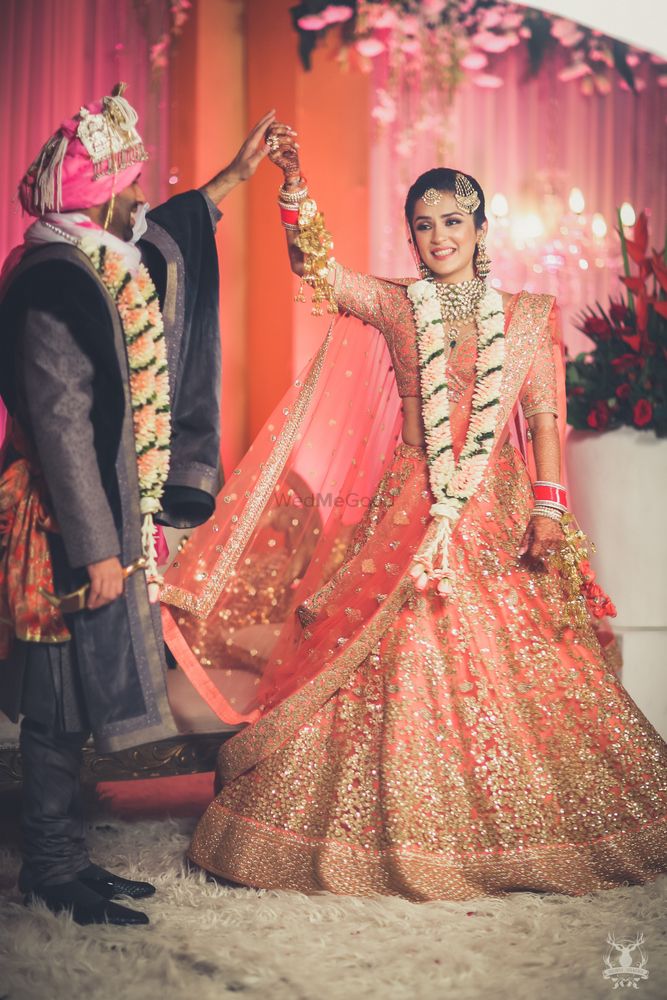 Photo of Peach and gold bridal lehenga on stage