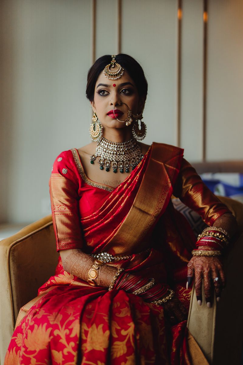 Young South Indian model in bridal red sari with golden jewelry set. Looking  away from camera Stock Photo - Alamy