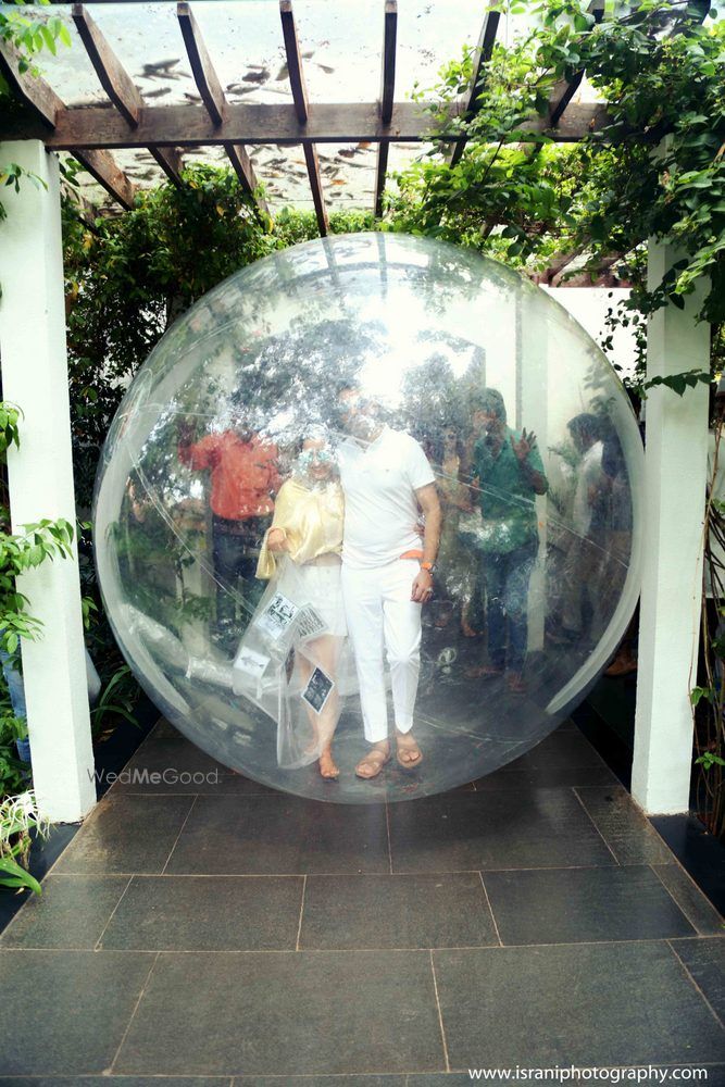 Photo of bride and groom in zorbing ball