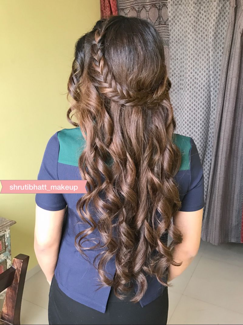 Photo of Open hairstyle with braided band and waves for engagement