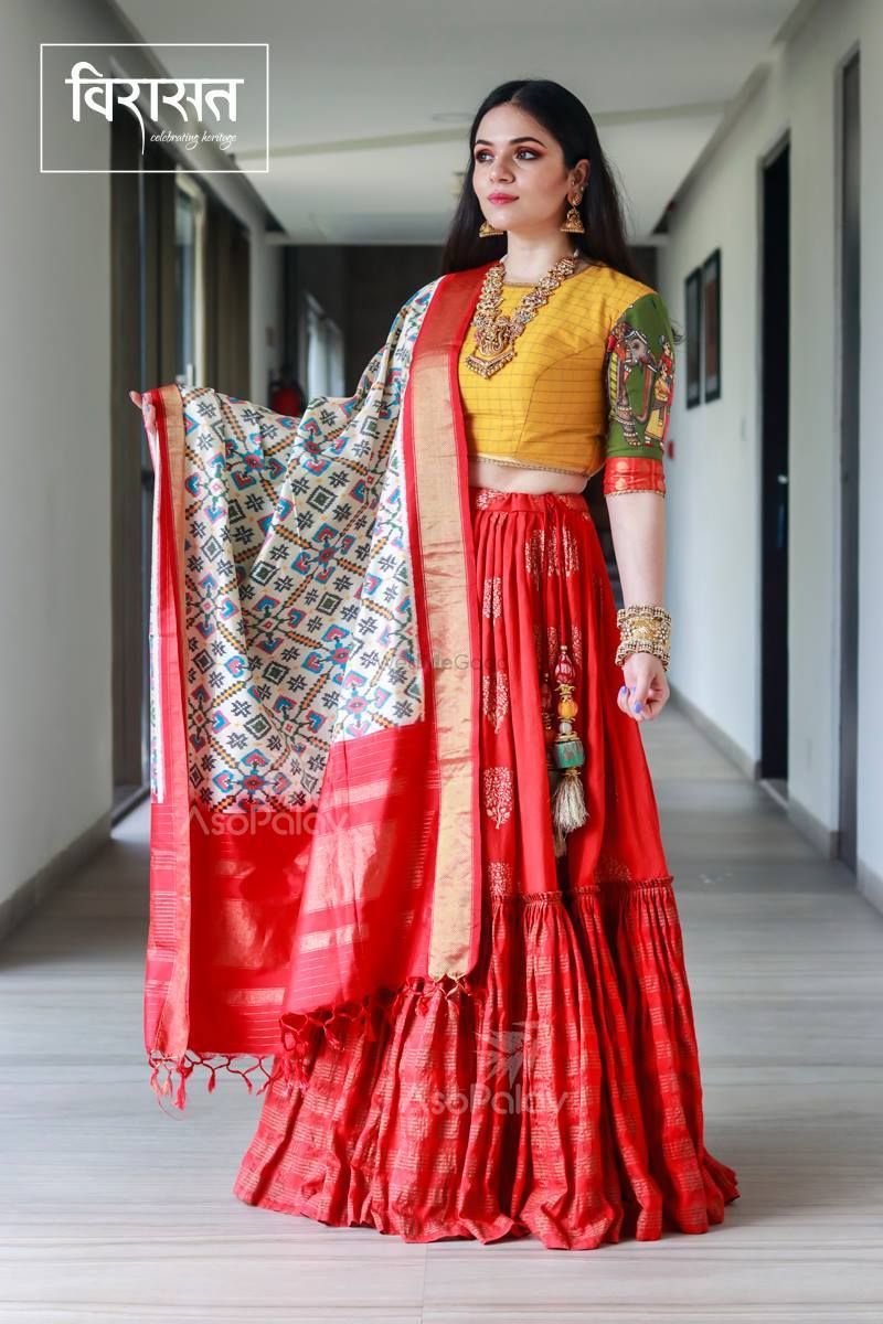 The quintessential red lehenga that's become synonymous with bridal attire,  makes its way into the cross-cultural wedding ceremony of our... | Instagram