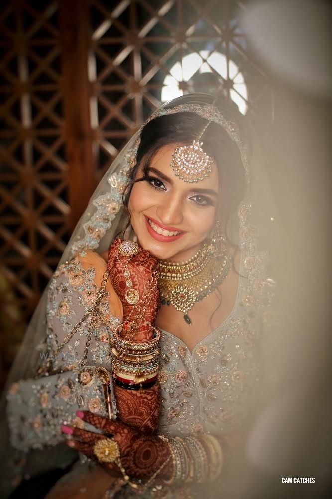 Photo of Happy bride wearing offbeat bridal lehenga