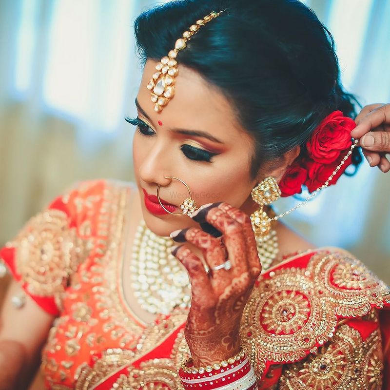 Photo of Bridal Makeup with Red Lehenga and Hairstyle with Roses
