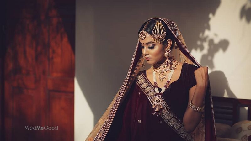 Photo of Bride in a stunning maroon lehenga.