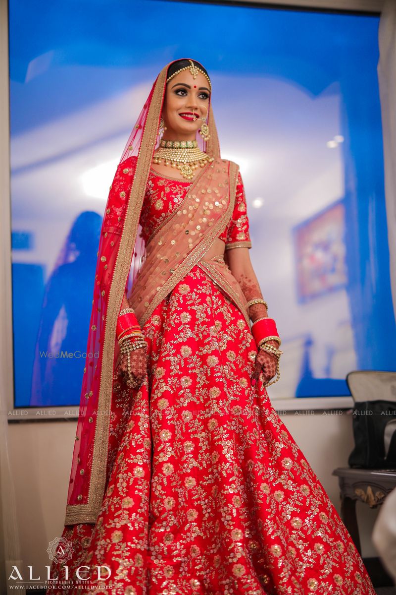 Photo of Bride posing in green and pink bridal lehenga with double dupatta