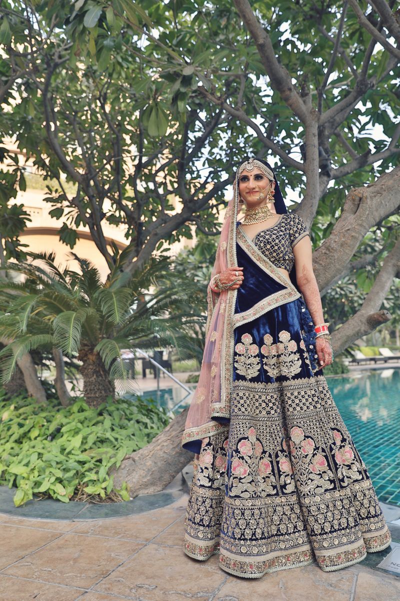 Photo of Navy blue velvet lehenga with pink dupatta and embroidery