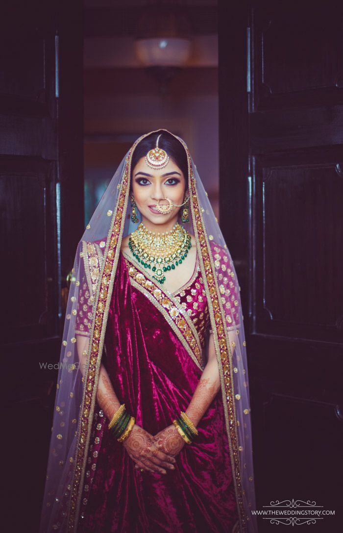 Photo of pastel bridal lehenga with unique green jewellery