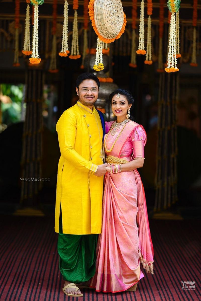 Photo of south indian bride and groom in contrasting outfits