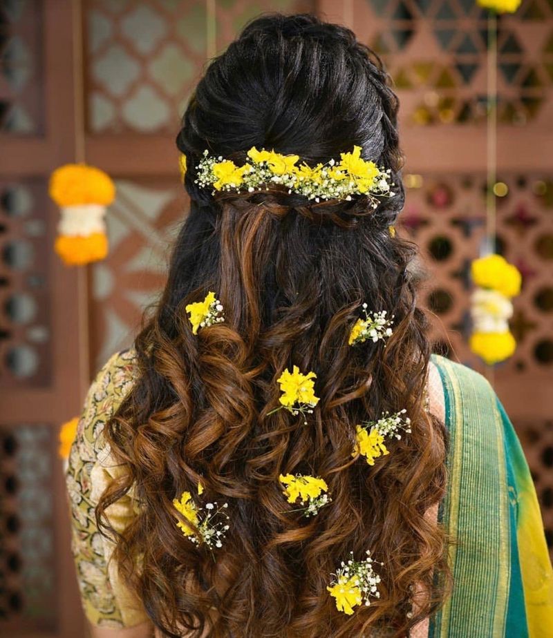 Photo of An open hairstyle with babys breath and small yellow flowers
