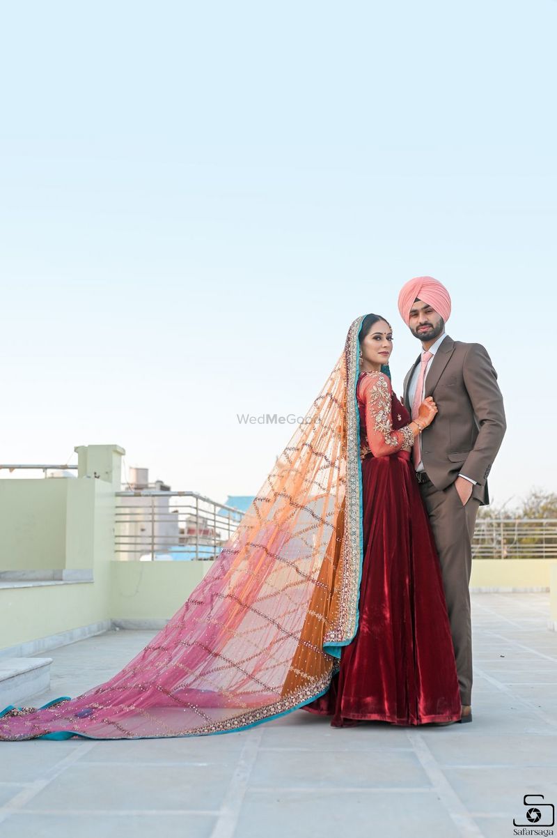 Dramatic engagement couple pose in red gown - photo by YNOT iMages