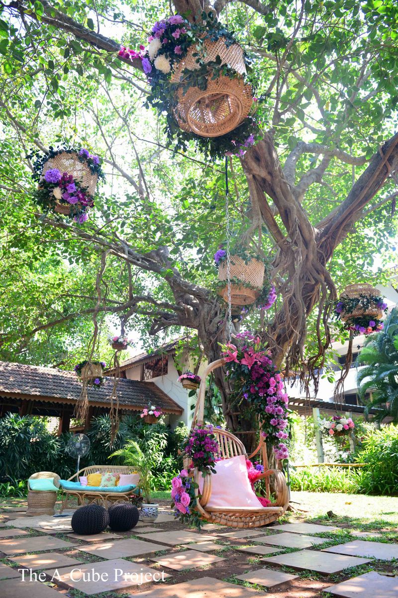 Photo of Jhoola setup with purple flowers and cane baskets.