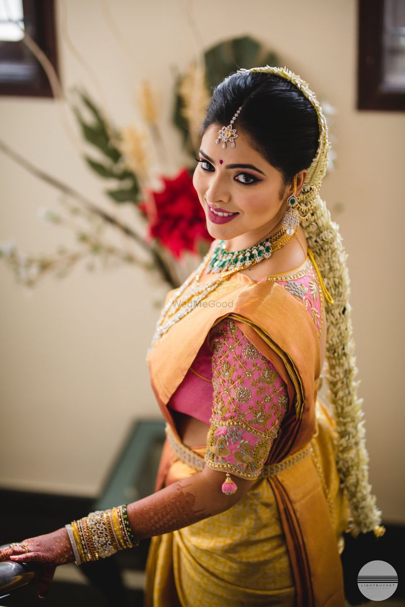 South Indian bridal look with gold kanjivaram and pink blouse