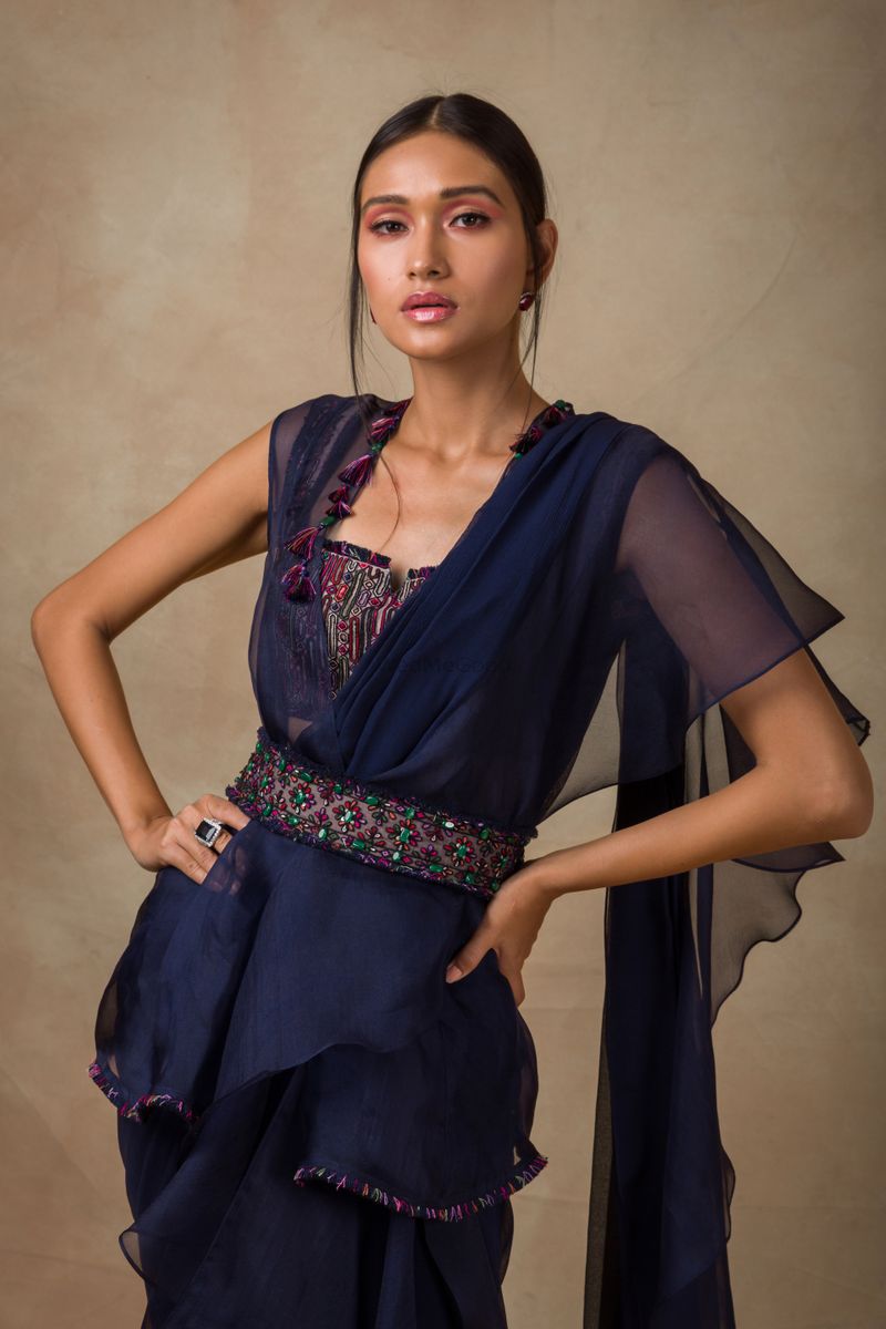 Navy blue ruffled saree with jacket and belt by Ridhi Mehra