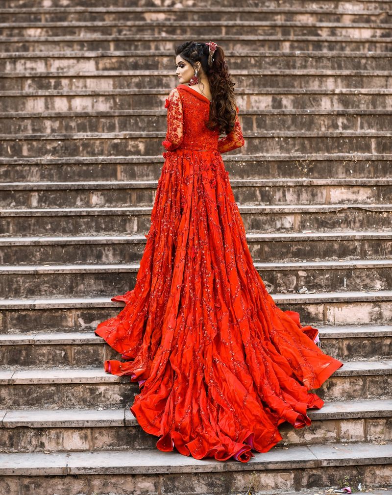 Red on red embroidered flare gown by Varsha Advani
