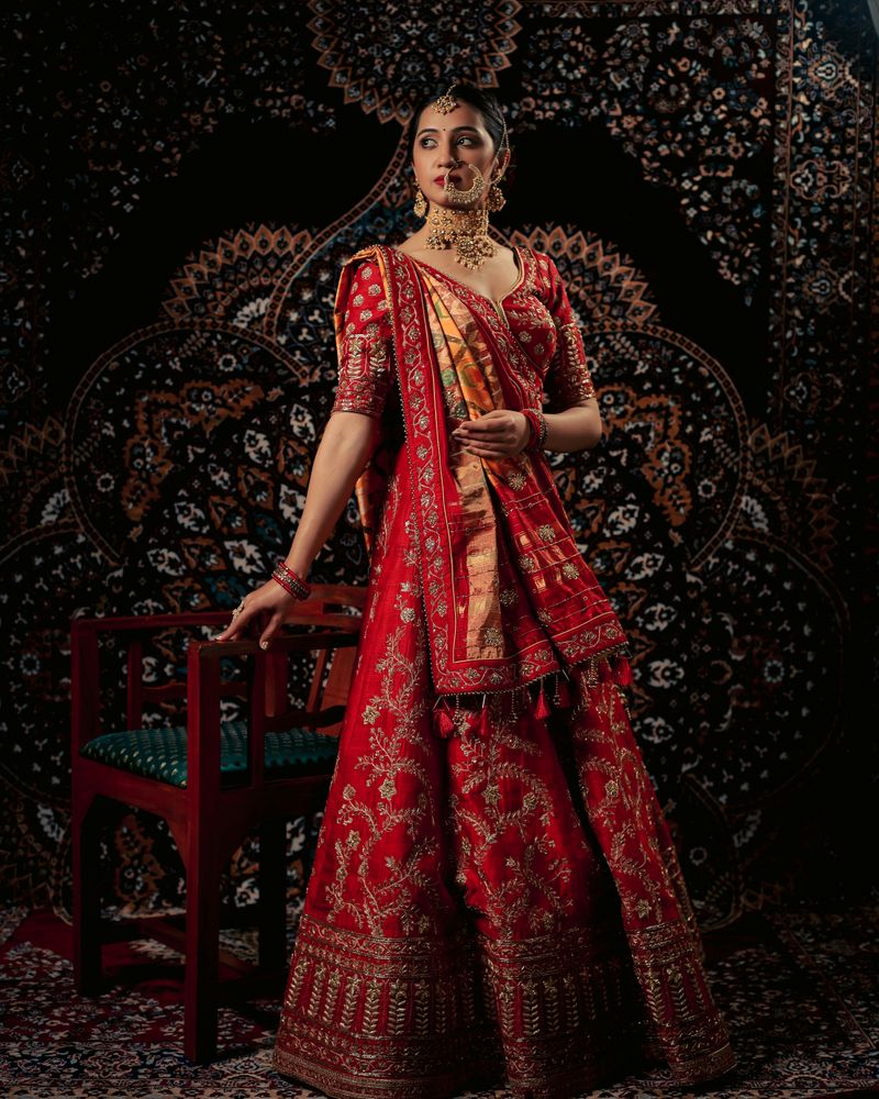Red bridal lehenga with patola dupatta by Creative Stylista Boutique